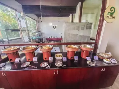 a counter with a bunch of bowls and plates at The Wave Lakeview Resort & Spa in Wayanad