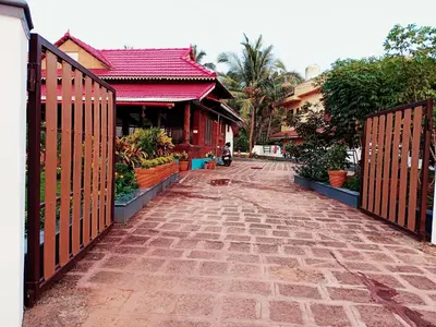 a brick street with a gate in front of a building at Beach Nest in Kannur