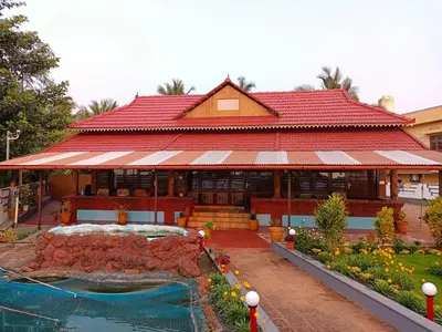 a large building with a fountain in front of it at Beach Nest in Kannur