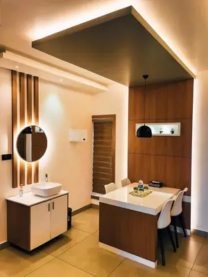a kitchen with a sink and a counter with a table at BBC Luxury Apartments in Perintalmanna