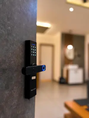 a remote control attached to a wall in a room at BBC Luxury Apartments in Perintalmanna