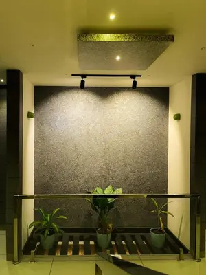 a room with potted plants on a wall at BBC Luxury Apartments in Perintalmanna