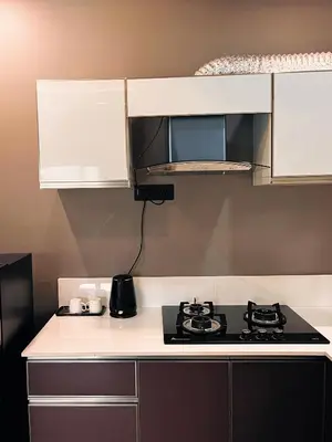 a kitchen with a stove and a microwave at BBC Luxury Apartments in Perintalmanna