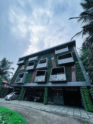 a building with plants on the side of it at BBC Luxury Apartments in Perintalmanna