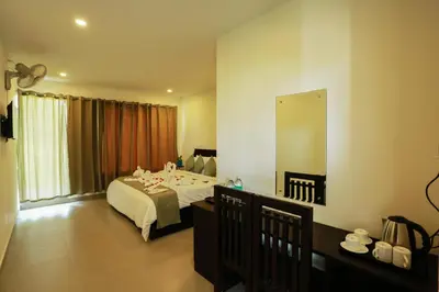 a bedroom with a bed and a large mirror at SATRA WAYANAD in Kalpetta