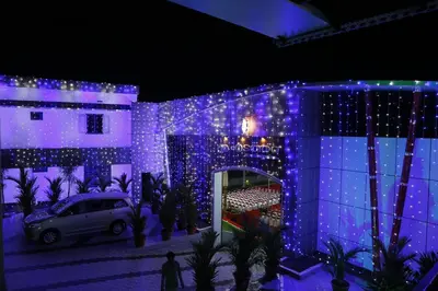 a building with blue lights on the side of it at AP Residency in Wayanad