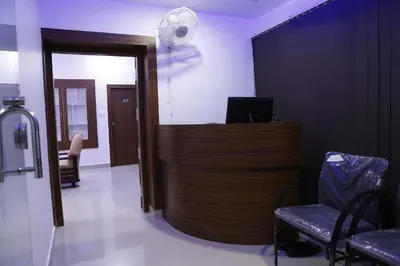 a waiting room with a desk and a fan at AP Residency in Wayanad
