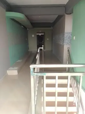 an empty room with a staircase in a building at Emirates Residency in Pudunagaram