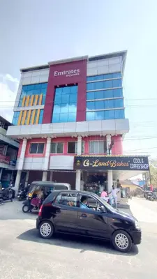 a black car parked in front of a building at Emirates Residency in Pudunagaram