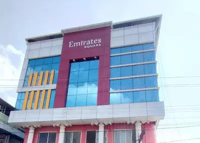 a building with an emirates group sign on it at Emirates Residency in Pudunagaram