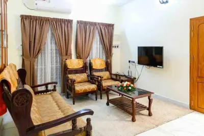 a living room with a couch and chairs and a table at Belljem Homes -your own private resort -6 BHK B in Trichūr