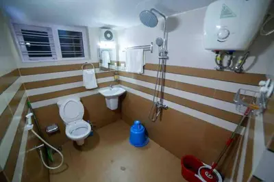 a bathroom with a toilet and a sink at Belljem Homes -your own private resort -6 BHK B in Trichūr