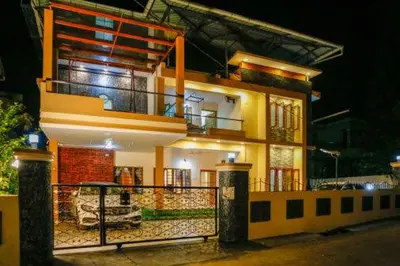 a large house with a balcony in front of it at Belljem Homes -your own private resort -5 BHK in Trichūr