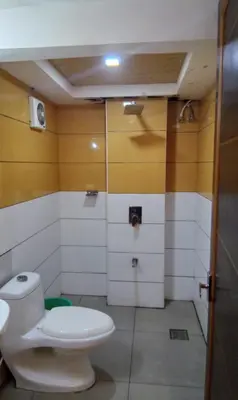 a bathroom with a toilet and a shower at GRACE RESIDENCY in Tirūr