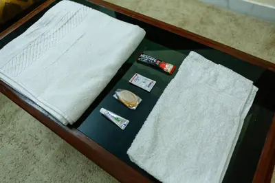 a table topped with white towels and toothbrushes at Belljem Homes -your own private resort -2 BHK GF in Trichūr