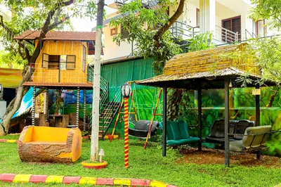 a playground with a swing and a gazebo at Belljem Homes -your own private resort -2 BHK GF in Trichūr