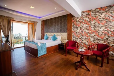 a hotel room with a bed and a stone wall at Vista Suites Doddabetta Ooty By Bestinn Leisure in Ooty