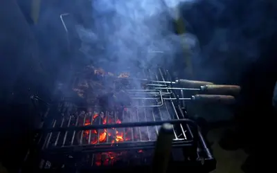 a grill with a bunch of hot dogs on it at Vista Suites Doddabetta Ooty By Bestinn Leisure in Ooty