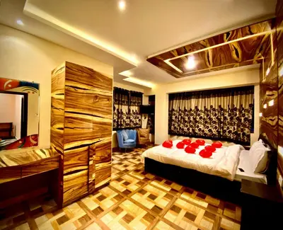a bedroom with a bed with red roses on it at MAGIC MIST RESORT in Ooty