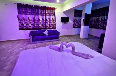 a bedroom with a large bed with a heart on it at MAGIC MIST RESORT in Ooty