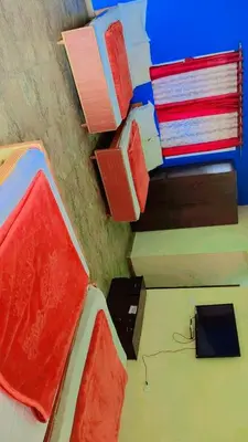 a room with a bed with boxes on the wall at MAGIC MIST RESORT in Ooty