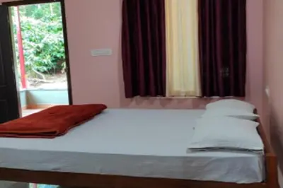 a bedroom with a white bed with a window at Lake View Homestay by StayApart in Madikeri