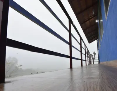 an empty room with a blue building with windows at Lake View Homestay by StayApart in Madikeri