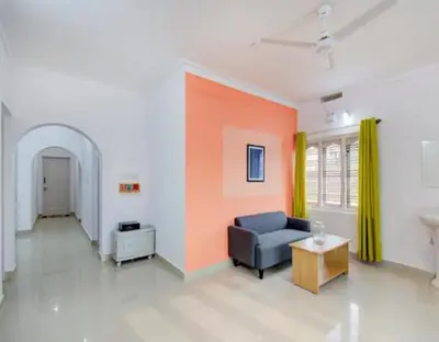 a living room with a couch and a table at Coorg Dream Land Homestay by StayApart, Kushalnagar in Kushālnagar