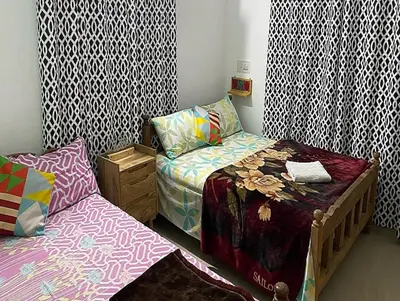 a small room with two beds in a room at Coorg Dream Land Homestay by StayApart, Kushalnagar in Kushālnagar
