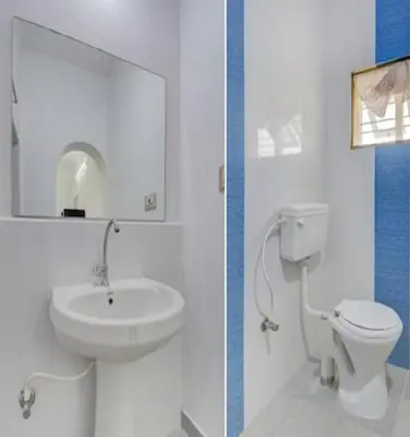 a white bathroom with a sink and a toilet at Coorg Dream Land Homestay by StayApart, Kushalnagar in Kushālnagar