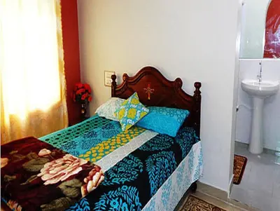 a bedroom with a bed and a sink at Coorg Dream Land Homestay by StayApart, Kushalnagar in Kushālnagar