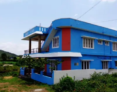 a blue house with a red and white stripe at Coorg Dream Land Homestay by StayApart, Kushalnagar in Kushālnagar