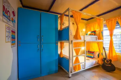 a bedroom with a bunk bed and a guitar at goSTOPS Coorg in Madikeri