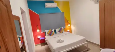 a small room with a bed in a room at goSTOPS Coorg in Madikeri