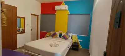a small room with a bed in a room at goSTOPS Coorg in Madikeri