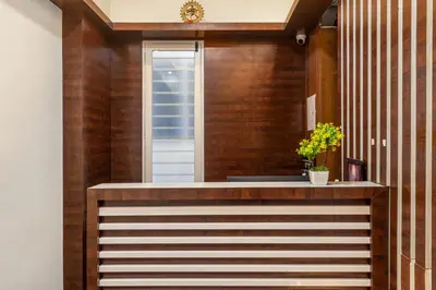 a home entry with wood paneling and a wooden wall at Treebo Sans Sarav Kushalnagar, 10 mins to Nisargadhama Island in Madikeri