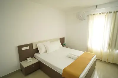 a bedroom with a large bed with a window at SN ROOMS in Perumbavoor
