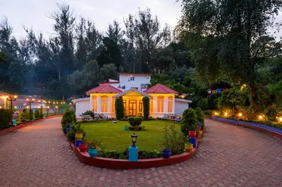 a garden in front of a house at night at goSTOPS Ooty in Ooty