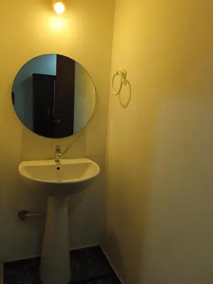 a bathroom with a sink and a mirror at Leo's Residency Coorg in Kushālnagar
