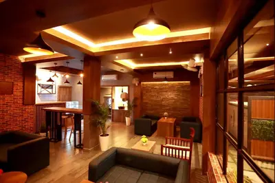 a living room with a couch and a table at ORFILA INN Airport Hotel in Angamali