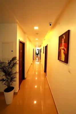a hallway of a hospital with a painting on the wall at ORFILA INN Airport Hotel in Angamali