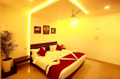 a bedroom with a large bed with red pillows at ORFILA INN Airport Hotel in Angamali