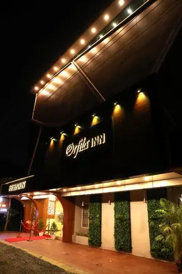 a building with a sign on it at night at ORFILA INN Airport Hotel in Angamali