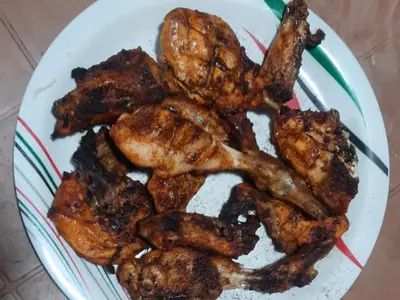 a plate of food with chicken wings on it at Honeybee Homestay by The Jungle Stay Groups in Vālpārai