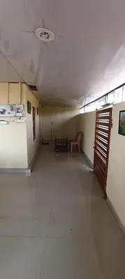 an empty hallway of a hospital with a chair in it at Honeybee Homestay by The Jungle Stay Groups in Vālpārai
