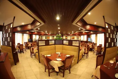a restaurant with tables and chairs in a room at RATHNA RESIDENCY in Coimbatore