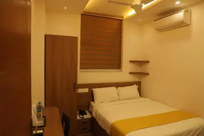 a small bedroom with a bed and a window at MEDLEY REGENCY in Palakkad