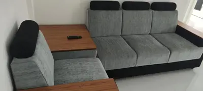 a couch and a table in a room at Yelza Hotel and Residence in Alwaye