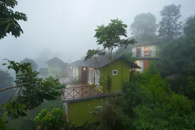 a house in the mist in the forest at Amrezy Resort and Spa by Stride, Wayanad in Vythiri