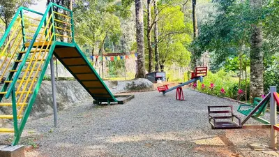a playground with colorful play equipment in a park at Skyfall 900kandi in Meppādi